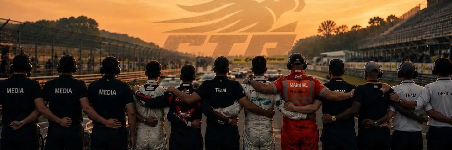 Media, teams, marshals and officials standing arm-in-arm on the grid at sunset.