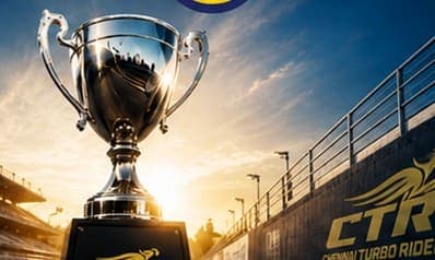Silver championship trophy on a CTR podium at golden hour.