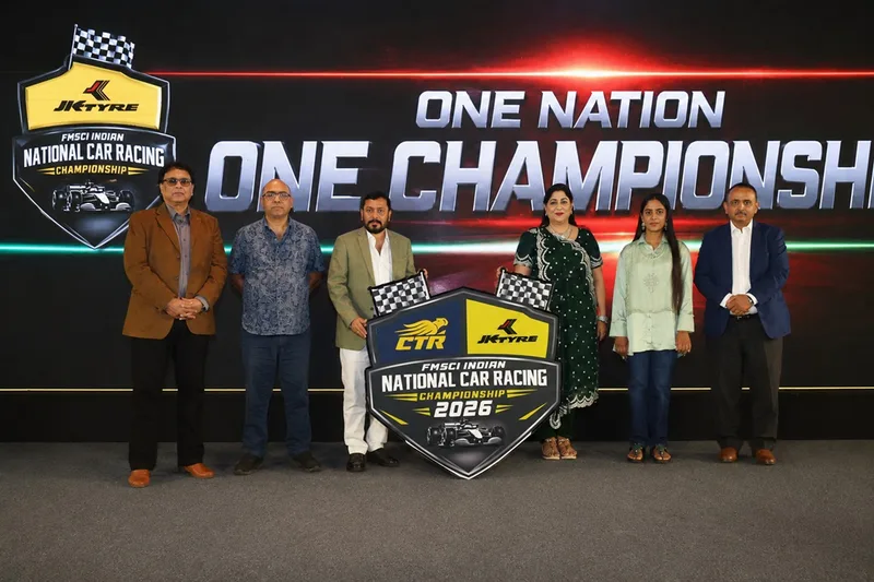Officials of CTR, JK Tyre and FMSCI stand on stage with the FMSCI Indian National Car Racing Championship 2026 shield, in front of a 'One Nation, One Championship' backdrop at the launch in Chennai